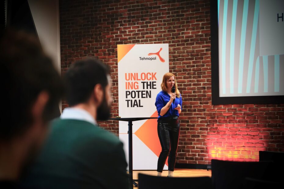 A woman giving a presentation in front of a crowd.