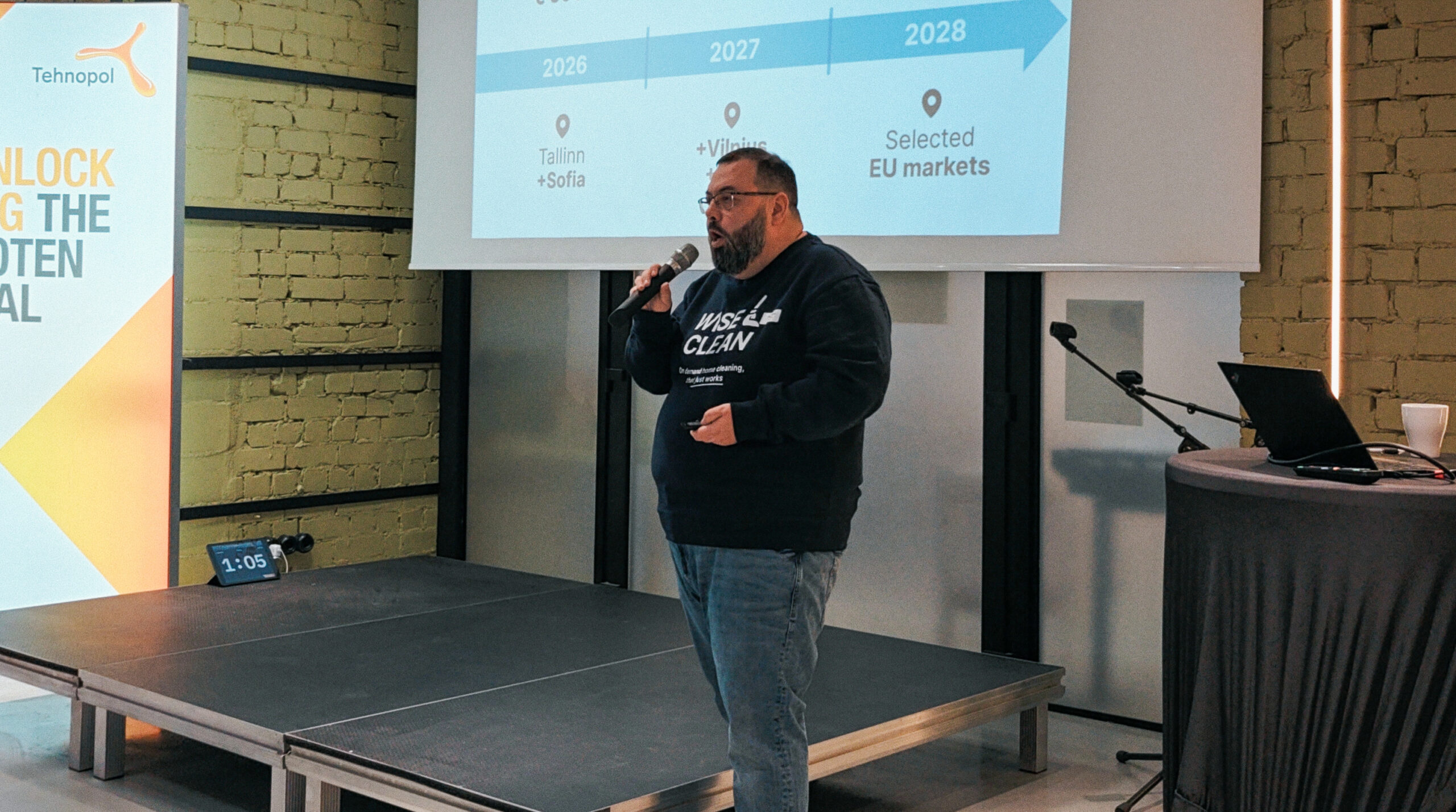 A man pitching on a stage.